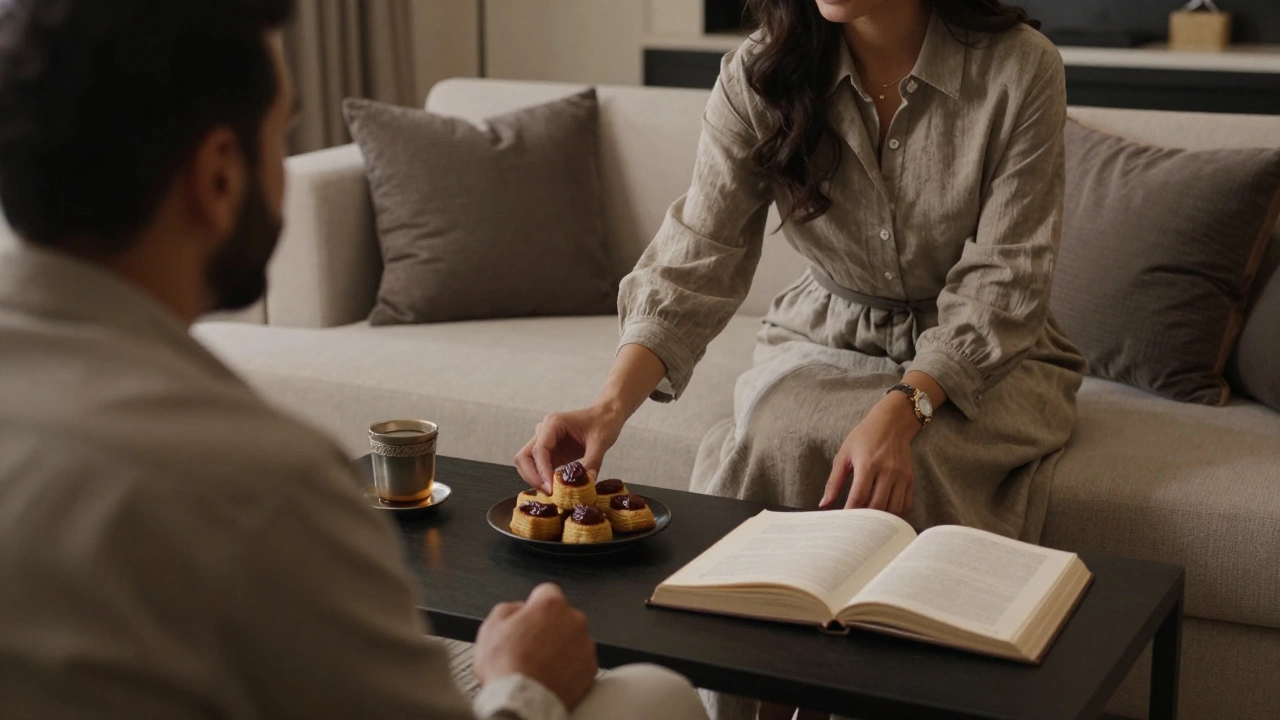 A woman offers Emirati pastries to a guest in a luxurious hotel suite, creating a moment of cultural connection.
